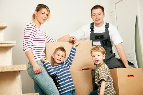 Movers carrying household items through a Waterloo apartment building